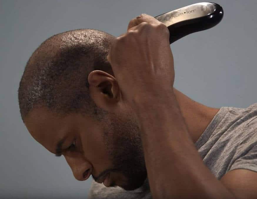 A man using Wahl professional hair clippers to style his hair.